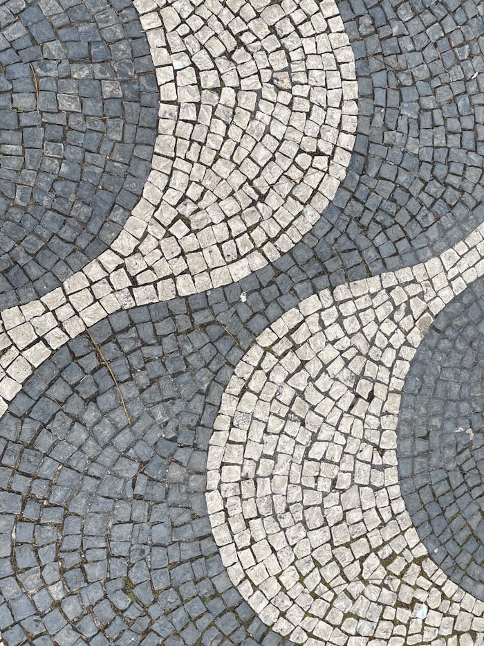 Close-up of a detailed mosaic pavement pattern in Madrid, showcasing artistic design and texture.